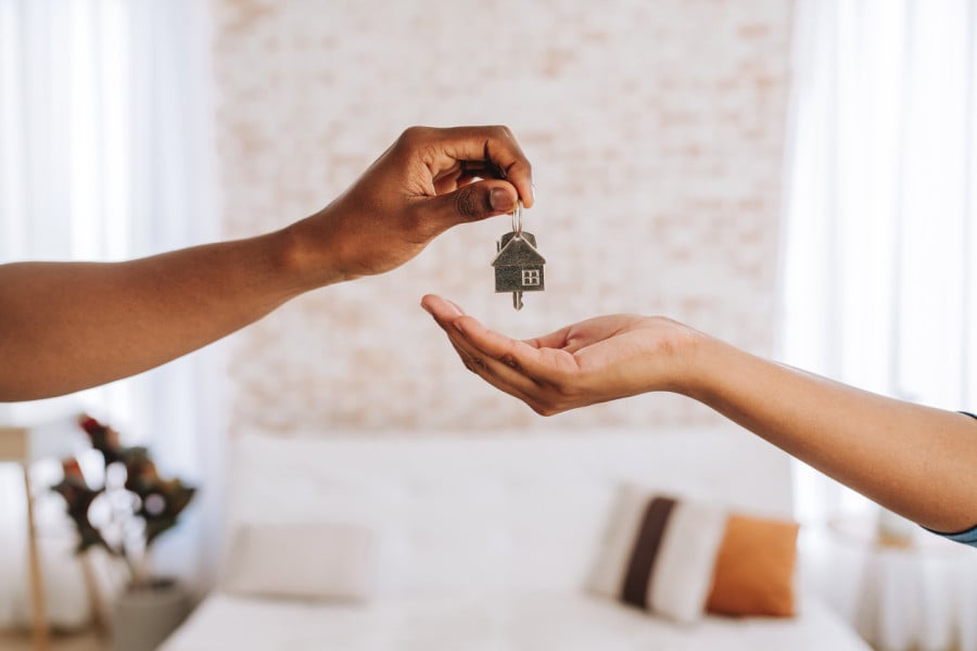 Agent handing keys to tenant