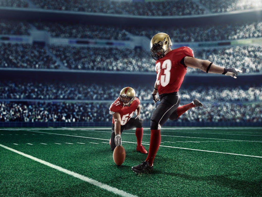 American footballer attempting field goal