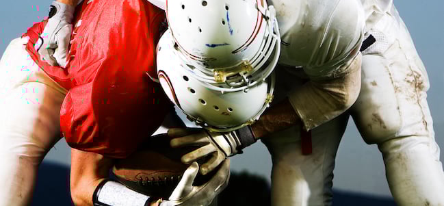 American Football players tackling