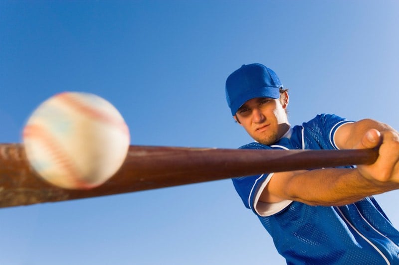Baseball player hitting the ball with a bat