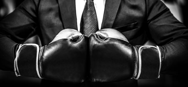 Boxing gloves on businessman in suit