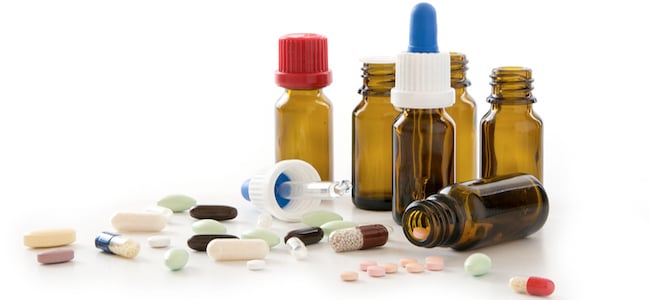 Capsules and bottle on white background
