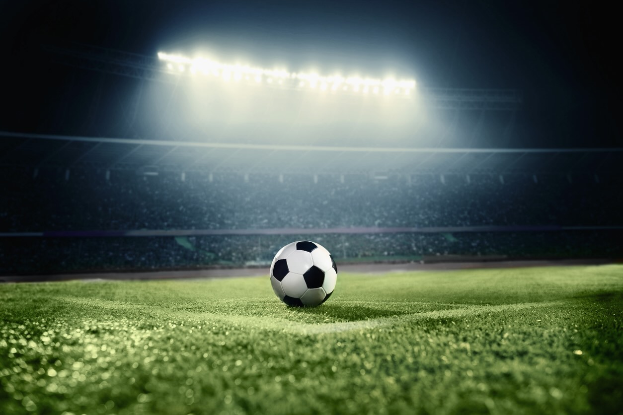 Title image of soccer ball on athletic field in stadium arena