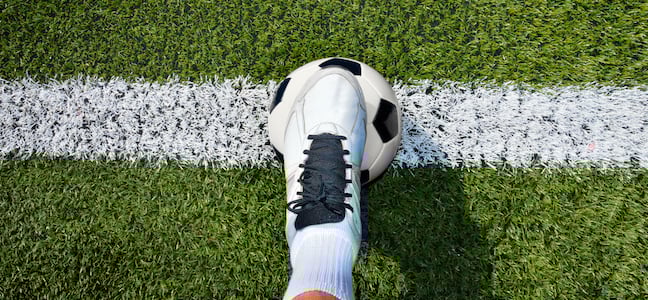 Start of a football game with player and football on line