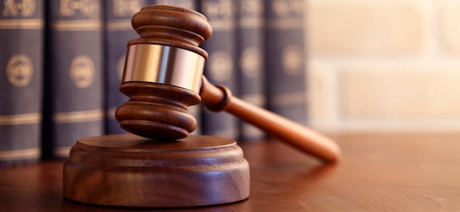 Gavel in front of books