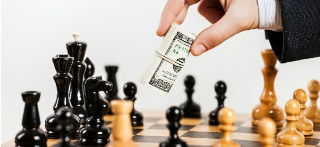 Hand_Passing_Money_Over_Chess_Game
