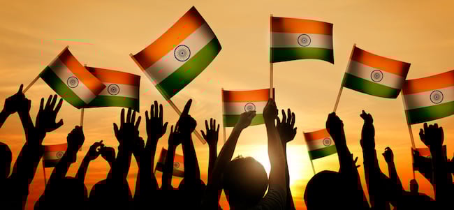 Indian flags waving in front of sunset
