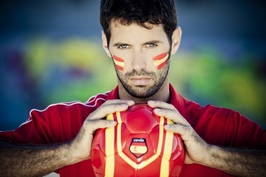 Man holding football with a Spanish flag