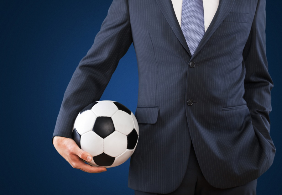 Man in suit holding Football