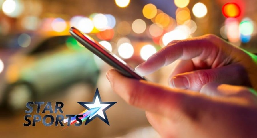 Person_Using_Mobile_in_Street_With_STAR_Sports_Logo Person_Using_Mobile_in_Street_With_STAR_Sports_Logo
