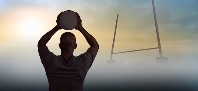 Rugby player on field with ball in mist
