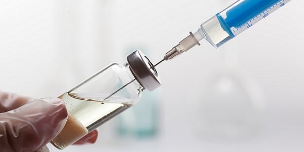Syringe in vial with transparent gloves 