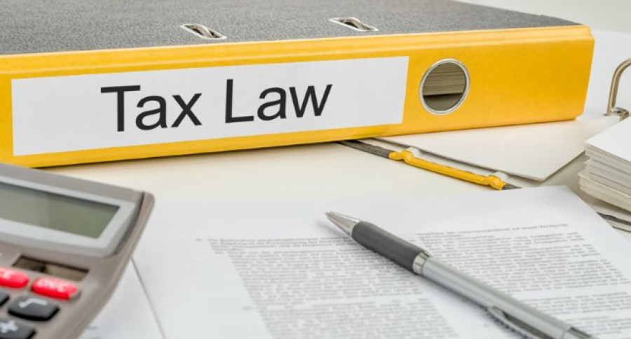 Tax_Law_on_Yellow_folder_with_paperwork Tax_Law_on_Yellow_folder_with_paperwork