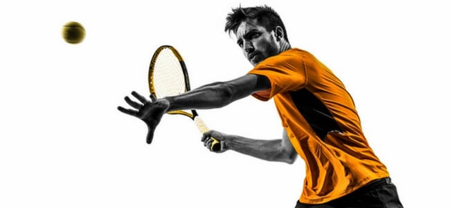 Tennis player about to hit ball