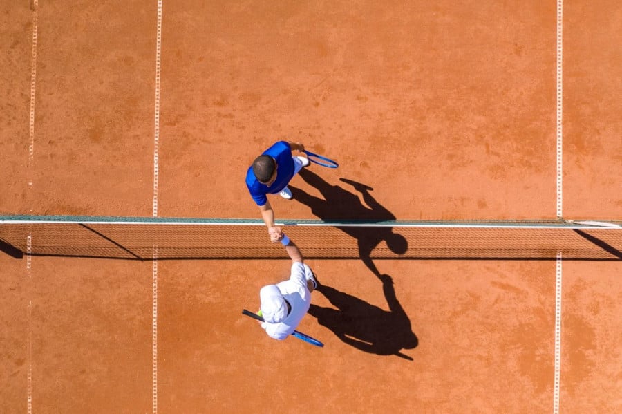 Two Tennis Players Greeting Each Other Over the Net Two Tennis Players Greeting Each Other Over the Net