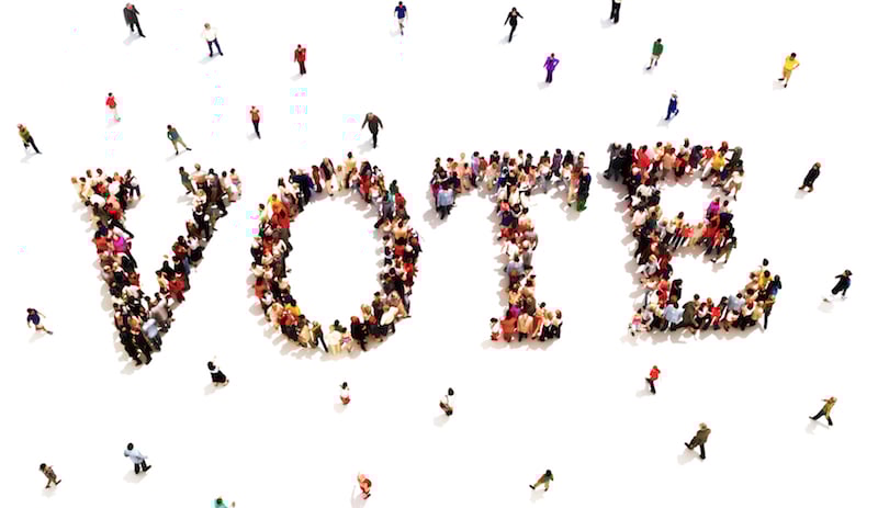 People joining together to spell the word vote
