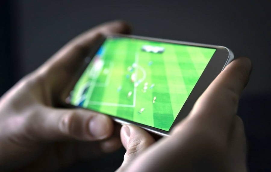 Man watching football on phone Man watching football on phone
