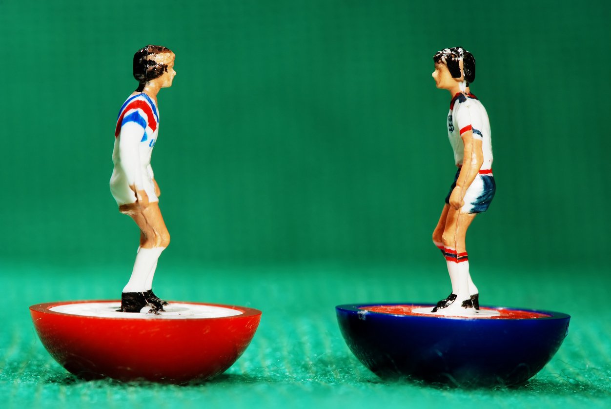 American and English Subbuteo figurines facing each other
