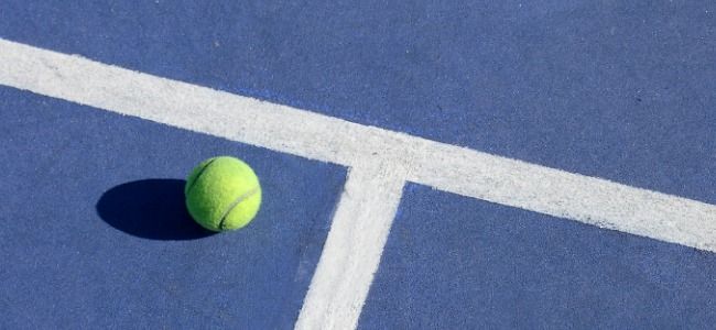 Tennis ball on blue court