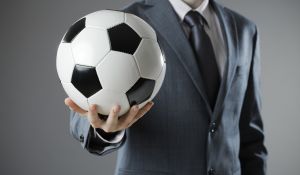 Businessman Holding Football