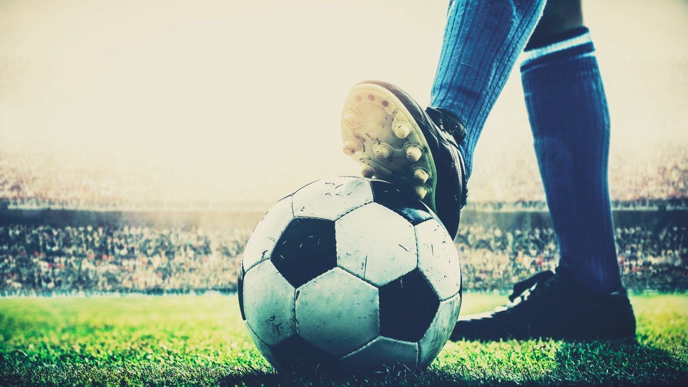 Footballer with studs on football