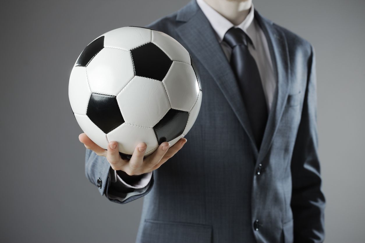 Businessman Holding Football